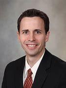 Smiling man in suit and tie, professional headshot