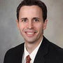 Smiling man in suit and tie, professional headshot